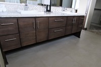Thumb vanity  contemporary style  quartersawn walnut  dark color  banded door  floating look  legs  banks of drawers  full overlay