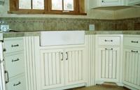 Thumb kitchen  traditional style  wide wainscot panel doors  apron front sink  wainscot columns or posts  painted with glaze