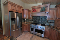 Thumb kitchen  craftsman style  quartersawn oak  medium color  flush mount  wood hood  appliance garage  diagonal corner cabinets