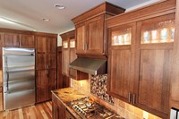 Thumb kitchen  shaker style  quartersawn oak  recessed panel  dark color  glass top panel  rain glass  staggered heights  angled bottom on range hood cabinet  full overlay