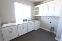 Thumb laundry or utility  shaker style  painted  recessed panel  open shelves  uppers above washer and dryer  standard overlay