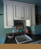 Thumb laundry or utility  traditional style  painted with glaze  recessed panel  short upper above the sink  standard overlay